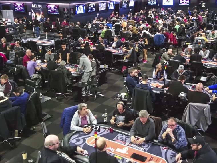 Packed tournament poker room at Playground Poker Club